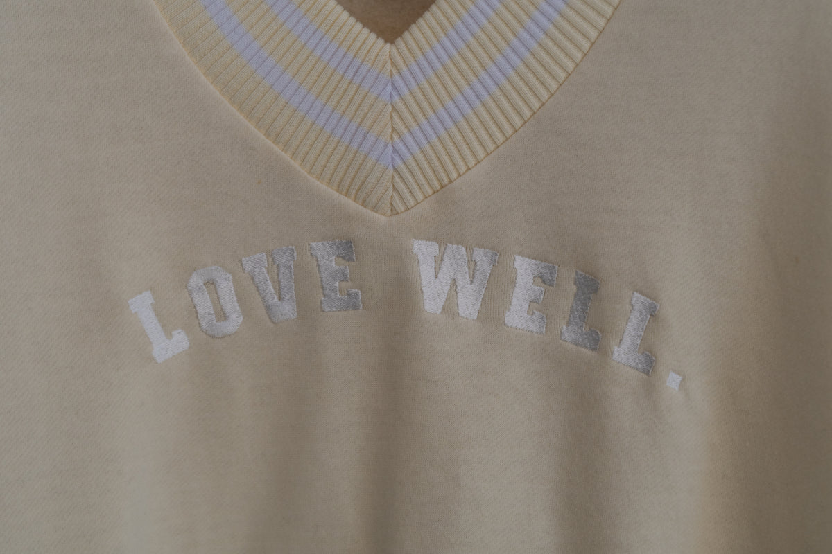 Love Well Vintage Ivy Varsity V-Neck Sweatshirt in White, front view, close-up detail